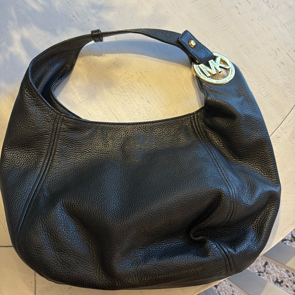 Never used Black leather, Michael Kors hobo purse with gold Michael Kors emblem